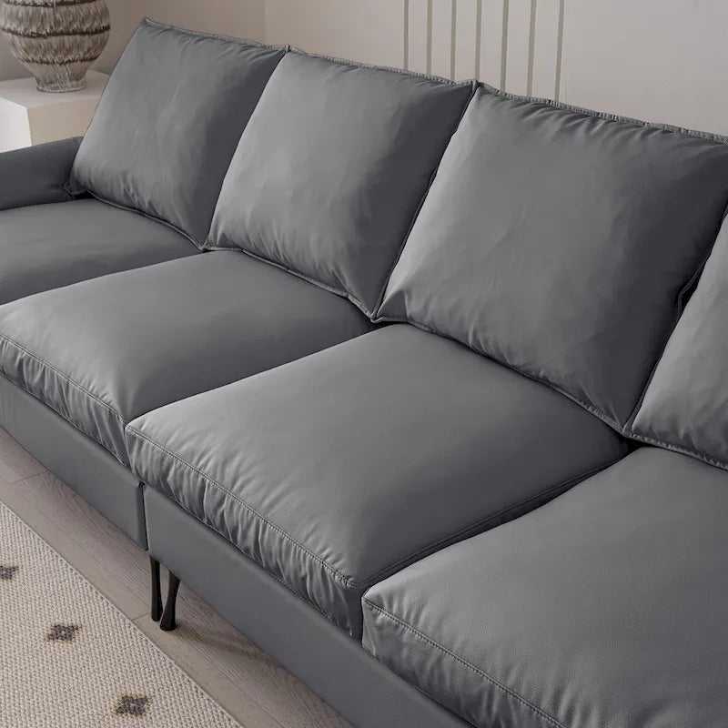 Divano moderno a L da 104,5 pollici con rivestimento in pelle tecnica e pouf convertibile, grigio scuro