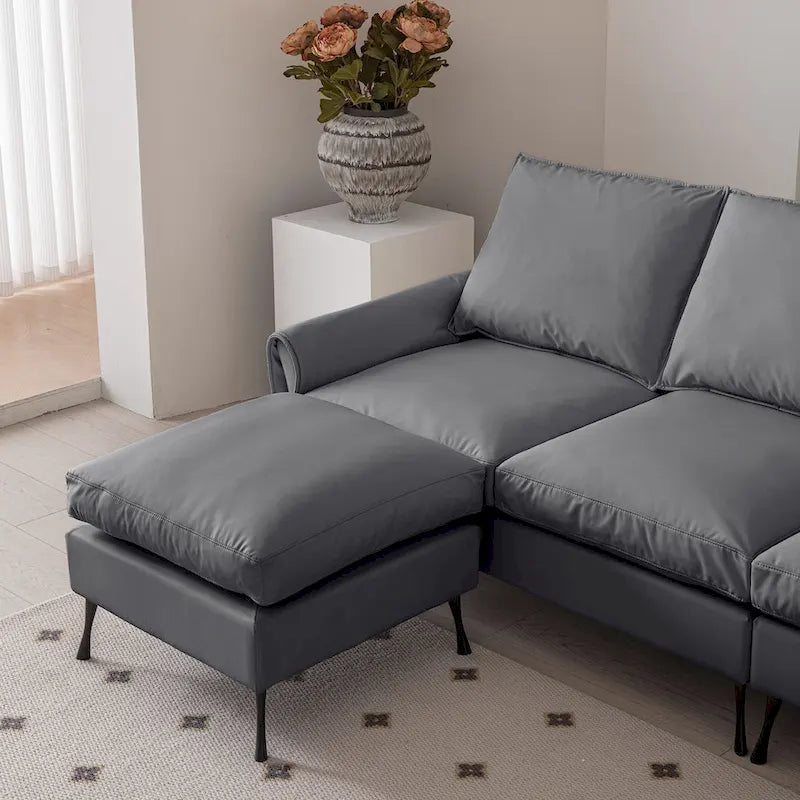 Divano moderno a L da 104,5 pollici con rivestimento in pelle tecnica e pouf convertibile, grigio scuro